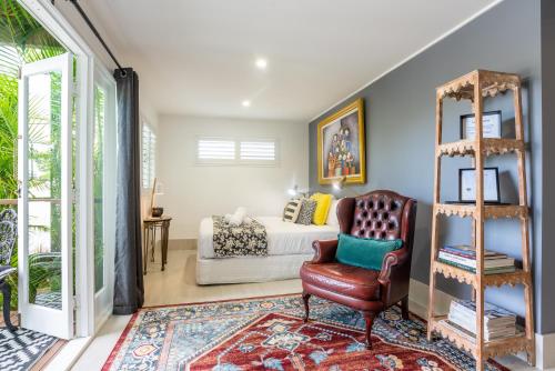 a living room with a couch and a chair at Contemporary Studio in the heart of Paddington in Brisbane