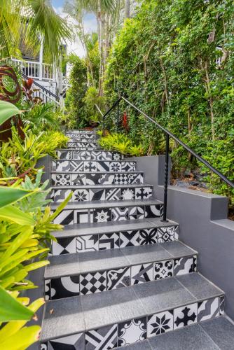 a set of stairs with black and white tiles at Contemporary Studio in the heart of Paddington in Brisbane