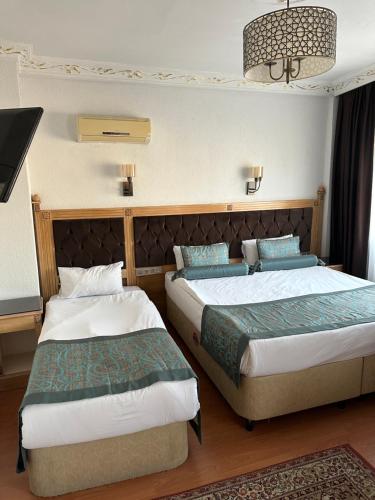 Ένα ή περισσότερα κρεβάτια σε δωμάτιο στο Blue Tuana Hotel Old City