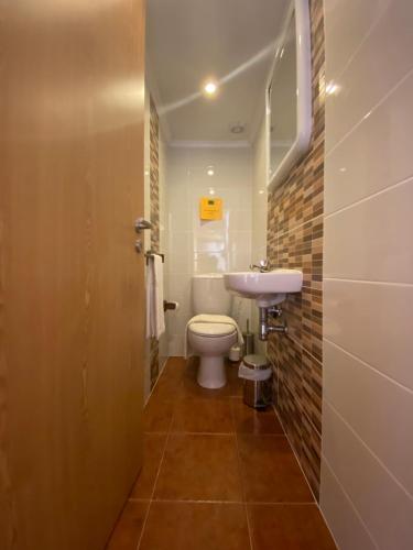 a small bathroom with a toilet and a sink at Apartment Praia Arrifana with BALCONY and SEA VIEW in Aljezur