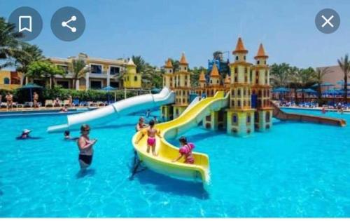 a group of people on a water slide at a water park at A two-room chalet in the village of Lale Land, Mirage Bay, Ecopark in Hurghada