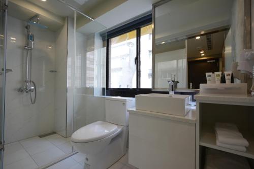 a bathroom with a toilet and a shower and a sink at Smile Inn - Taipei Main Station in Taipei