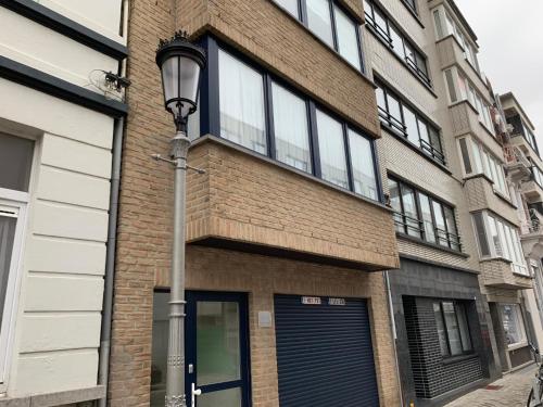 a brick building with a street light in front of it at Appartement 90m2 op 70m van het strand. in Ostend
