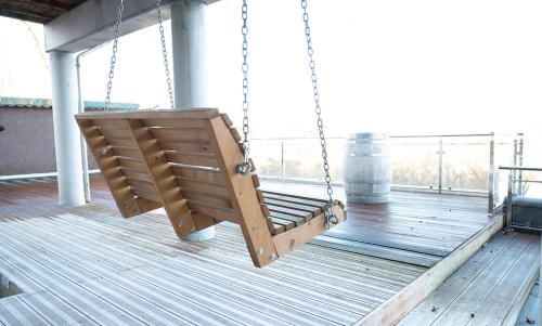 a swing on the deck of a building at Seehaus Plön in Plön