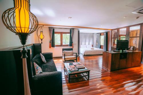a living room with a couch and a table at Villa Samadhi by Samadhi Age 12 and Above Only in Kuala Lumpur