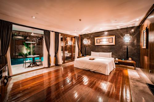 a bedroom with a bed and a wooden floor at Villa Samadhi by Samadhi - Adults Only in Kuala Lumpur