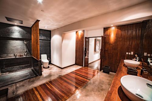 a bathroom with a sink and a toilet at Villa Samadhi by Samadhi - Adults Only in Kuala Lumpur