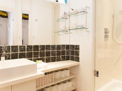 a bathroom with a sink and a shower at Roof Terrace Flat in Hampstead Pass The Keys in London