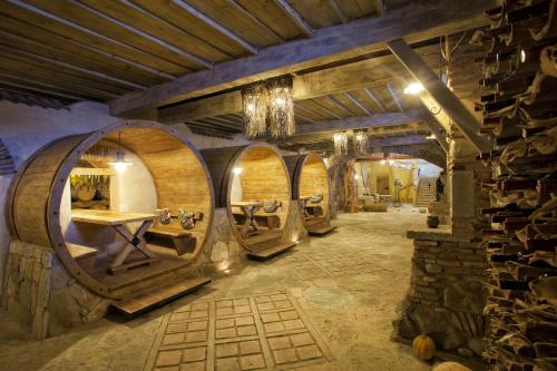 a wine tasting room with a bunch of wine barrels at Ambassadori Kachreti Golf Resort in Kachretʼi