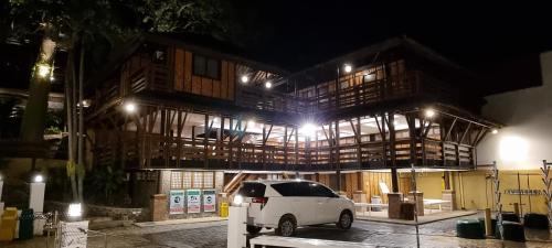 a white van parked in front of a building at night at Aquaventure Reef Club in Mabini