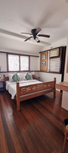 a bedroom with a bed and a ceiling fan at Aquaventure Reef Club in Mabini