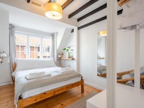 Schlafzimmer mit einem Bett und einem Fenster in der Unterkunft Pass the Keys The Hay Loft in Canterbury
