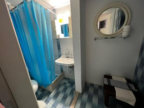 a bathroom with a sink and a toilet and a mirror at Astra House in Paralio Astros