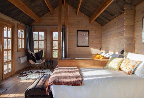 a bedroom with a large bed in a wooden cabin at Pian Del Mund in Borgomale