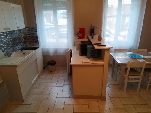 a kitchen with a sink and a counter top at Charmant studio centre bourg in Woincourt