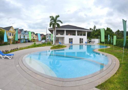 a large swimming pool in front of a house at 4BR Townhouse at PonteFino Residences Batangas City in Batangas City