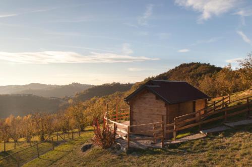 a small cabin on a hill with a fence at Pian Del Mund in Borgomale