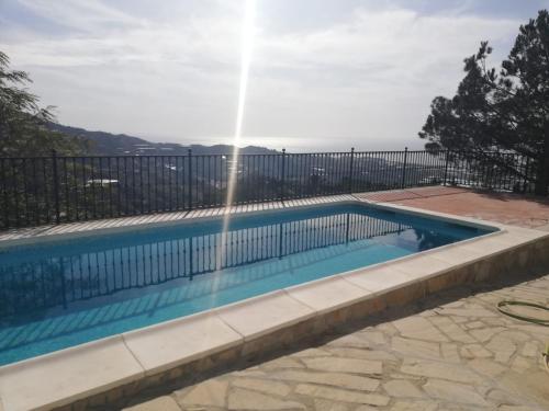 a swimming pool with a water fountain at Casa Antonia in Algarrobo