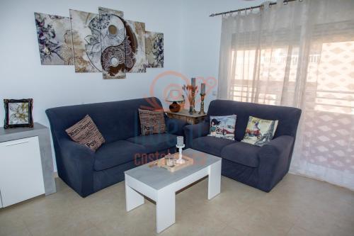 a living room with two blue couches and a table at APARTAMENTO ZEN. TEULADA. LIVE IT COSTABLANCA in Teulada