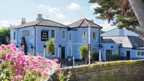 a blue house with flowers in front of it at The Boat House - Isle of Wight in Seaview