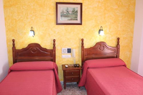 Postel nebo postele na pokoji v ubytování Hotel Doña Carmen