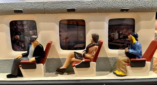four figurines of people sitting on a train at Stay-K-Belfast Cosy Entire House 10 mins from City Centre in Belfast