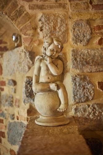 a statue of a little girl sitting on a potty at Antica Dimora in San Gimignano