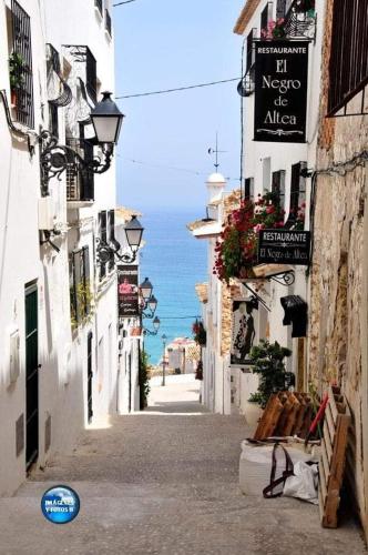 a narrow street with a view of the ocean at altea home centre one badroom in Altea