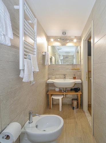 a white bathroom with a sink and a toilet at B&B Da Pio in Pietrasanta