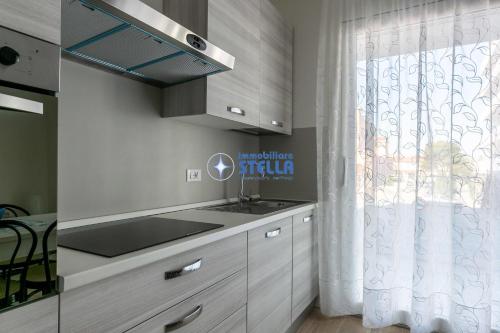 a kitchen with a sink and a counter top at Condominio Medusa in Lido di Jesolo