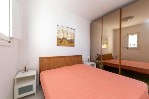 a bedroom with a bed with an orange bedspread at Residence Saint Nicholas in Lido di Jesolo