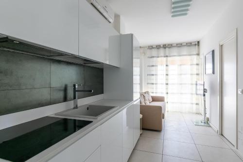 a kitchen with a sink and a couch in a room at Residence Saint Nicholas in Lido di Jesolo