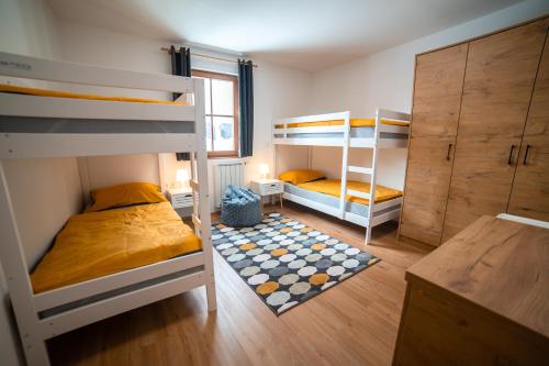 a room with two bunk beds and a desk at Apartment Bolfenk Pohorje in Hočko Pohorje