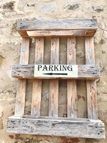 a sign that says parking on the side of a wall at Birillo 1824 in Poggibonsi