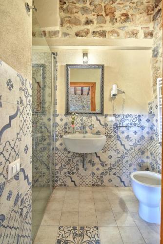 a bathroom with a tub and a sink and a mirror at Antica Dimora in San Gimignano