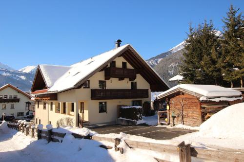 a house with snow on the roof at Appartement Valentin in Ehrwald