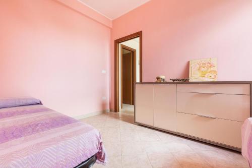 a bedroom with a bed and a dresser at Casa La Torre by BarbarHouse in Torre Mozza