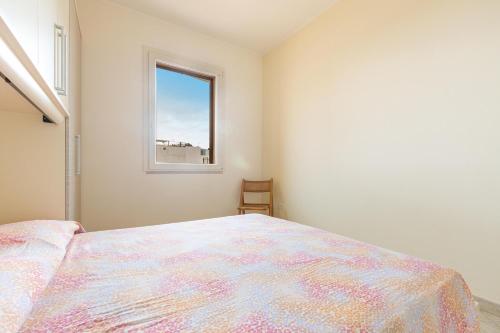 a bedroom with a large bed and a window at Casa La Torre by BarbarHouse in Torre Mozza
