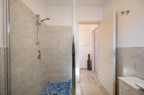 a bathroom with a shower with a glass door at Luci Apartment Sea Beach in Avola