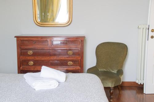 a bedroom with a bed and a dresser and a mirror at Casa Rossana - WelcHome in Cannobio