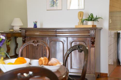 a wooden cabinet with two bowls of fruit on it at Casa Rossana - WelcHome in Cannobio