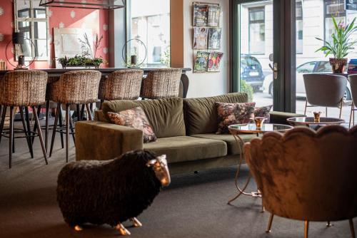 a living room with a couch and a chicken in it at V Hotel Helsingborg; BW Premier Collection in Helsingborg