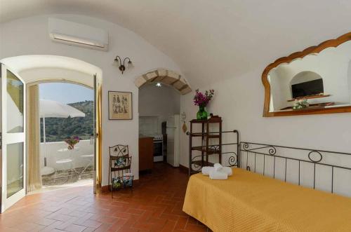 a bedroom with a bed and a view of a bathroom at Agriturismo Madonna Incoronata in Mattinata