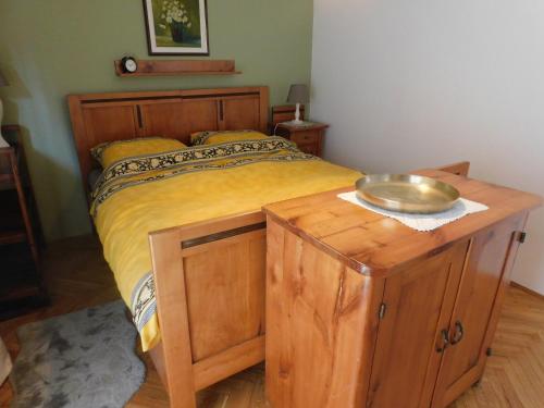 a bedroom with a bed with a bowl on a wooden table at Vali's Paradise in Ptuj