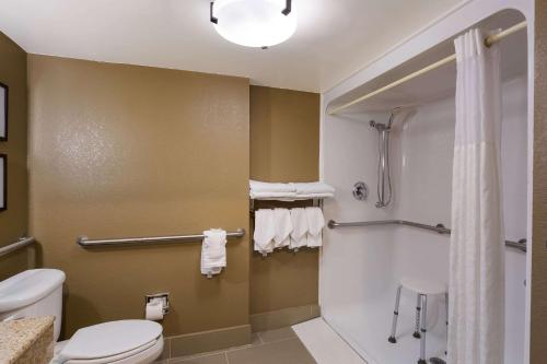 a bathroom with a toilet and a shower at Comfort Suites Near University in North Brunswick