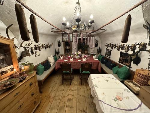 a dining room with a table and a chandelier at Ski-in & Out Alpine Style Apartment near Kitzbühel in Mittersill