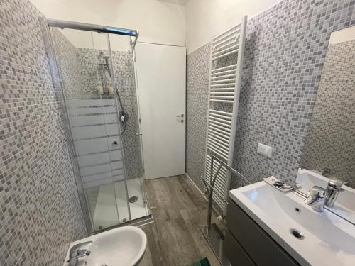 a bathroom with a shower and a sink and a toilet at Hotel Diffuso Il Portichetto sulla collina a Vezio Perledo in Perledo