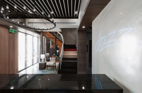 a hallway with a staircase in a building at Herb Art Hotel in Keelung