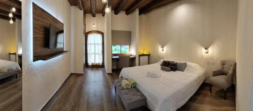 een slaapkamer met een groot wit bed in een kamer bij Pilgrim's Rest - Descanso del Peregrino in Chacras de Coria