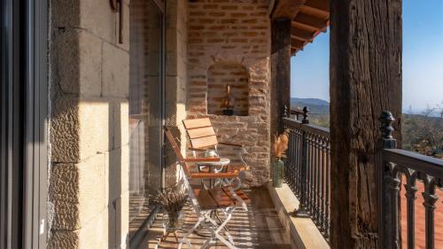 a pair of chairs sitting on the balcony of a house at Nadas Kazdağları in Canakkale